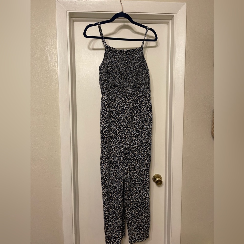 Old Navy jumpsuit with white and cream flower pattern.